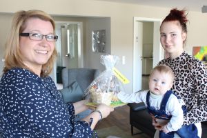 Wir wissen um die Bedürfnisse junger Eltern: Eine Mitarbeiterin und eine Bewohnerin mit ihrem Baby i